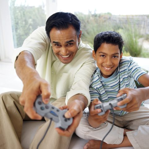 father and son playing video games