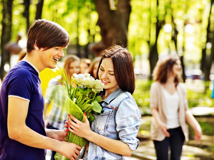 Couple of teenager on date outdoor.