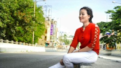 A beautiful girl siting on road side