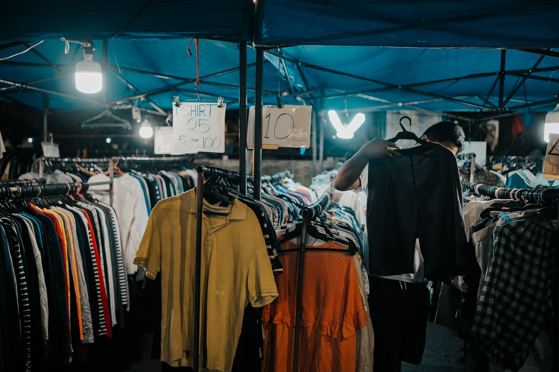 Explore a vibrant night market in Iligan City, Philippines, showcasing clothes and lively ambiance.