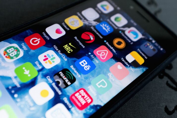 Detailed view of smartphone displaying multiple app icons on screen, highlighting technology use.
