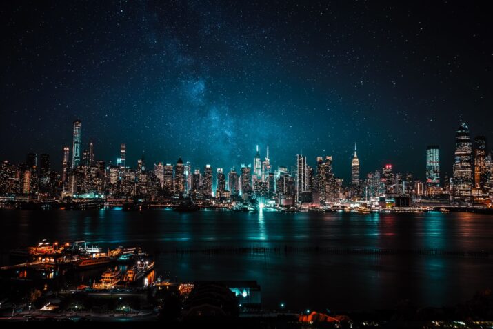A mesmerizing view of New York City's illuminated skyline under a starry night sky.