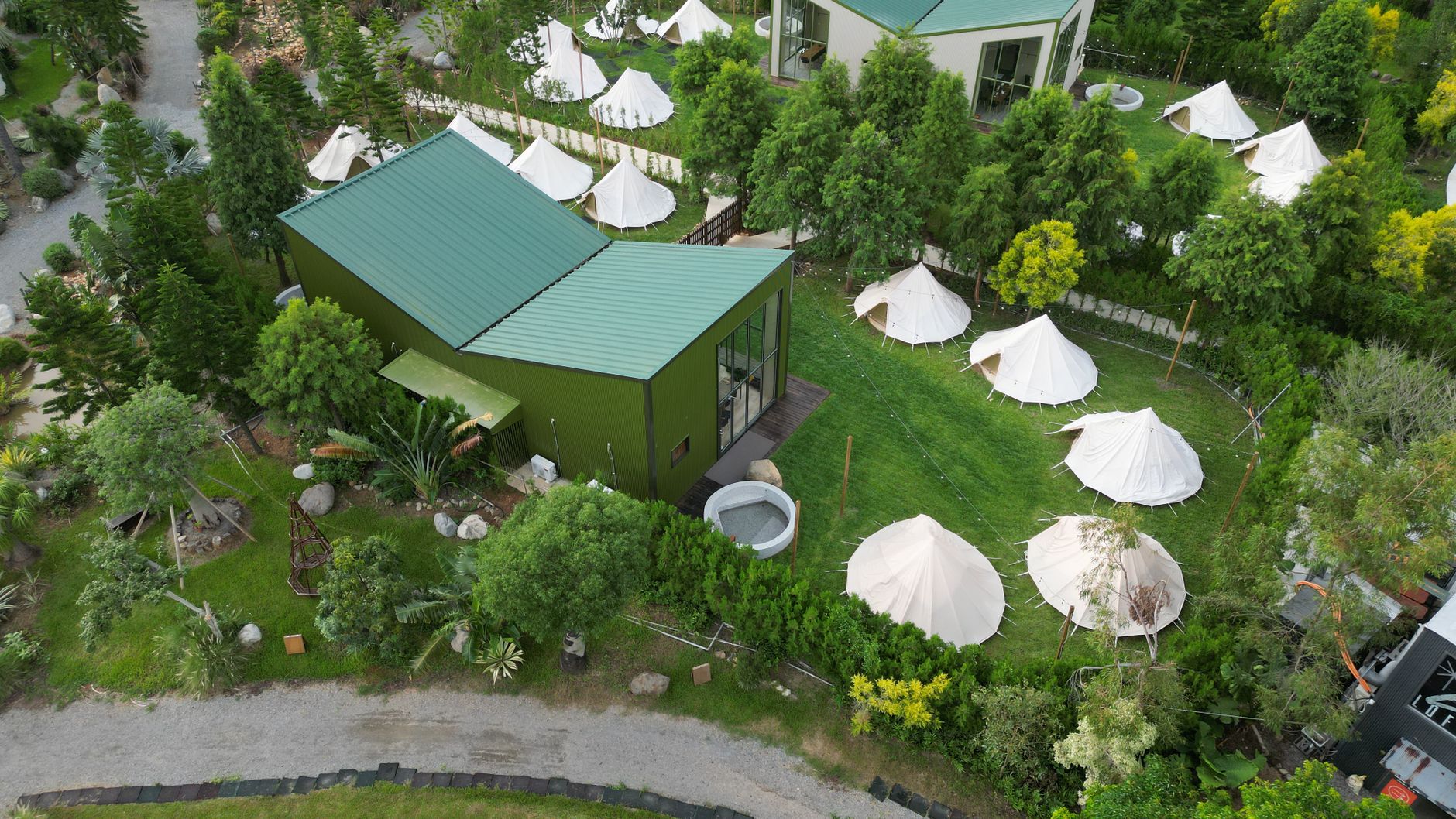 Bird's-eye view of a glamping area with modern architecture and lush greenery in Miao-li County, Taiwan.