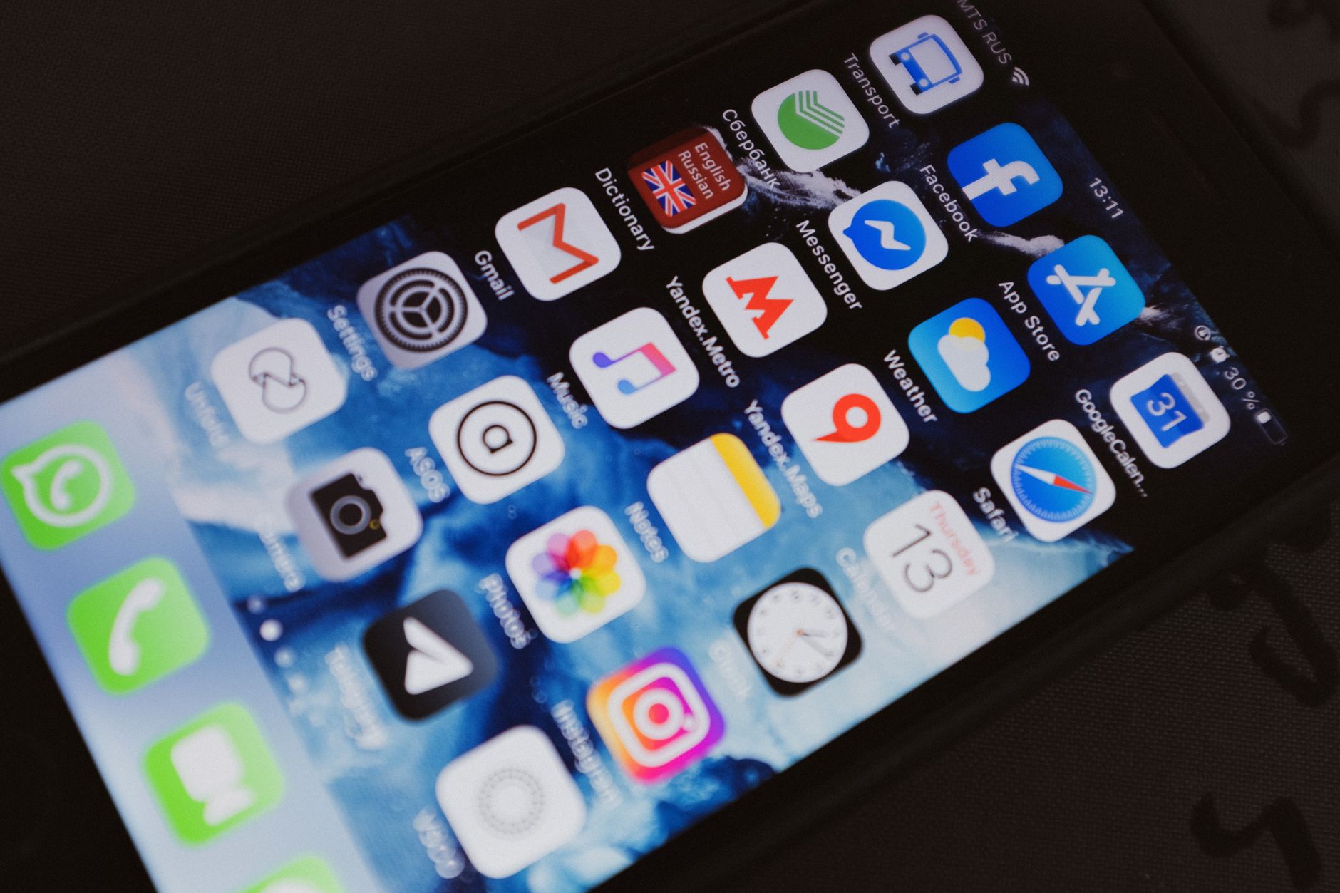 Close-up of a smartphone displaying popular social media and productivity apps on its screen.