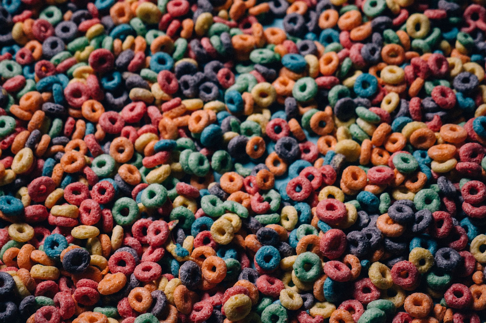 A vibrant close-up of multicolored cereal loops, capturing their playful texture and color.
