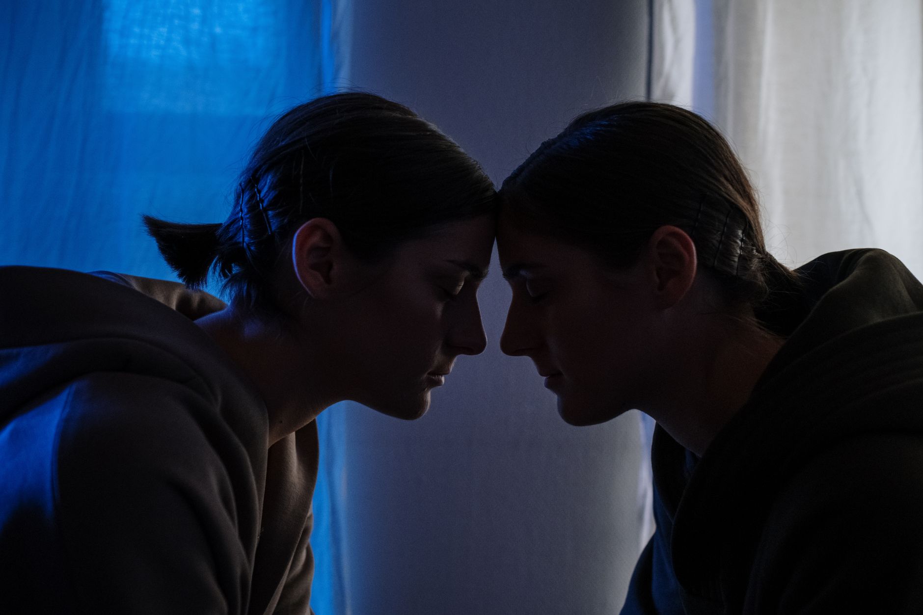 Two women sharing an intimate moment, highlighting themes of connection and mental health.