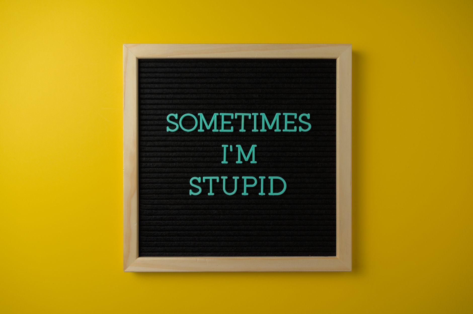 A letter board with a humorous message on a vibrant yellow background.
